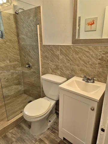 a bathroom with a toilet sink and shower