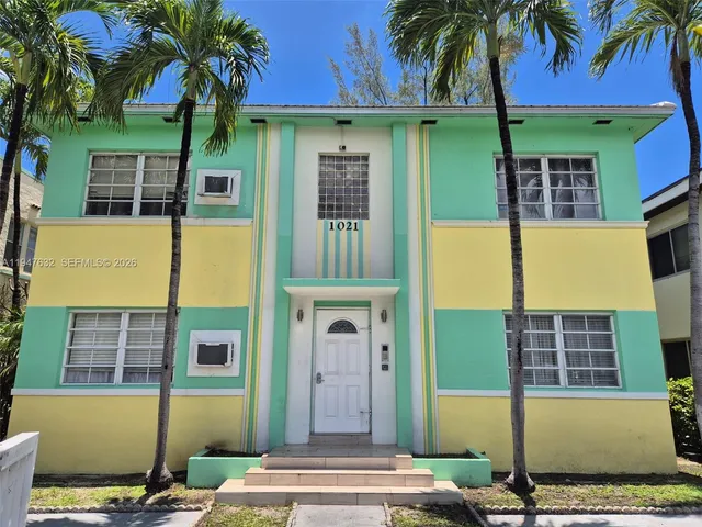 a front view of a building with a garden