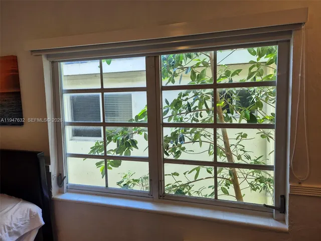 a view of a room that has a bed and a window