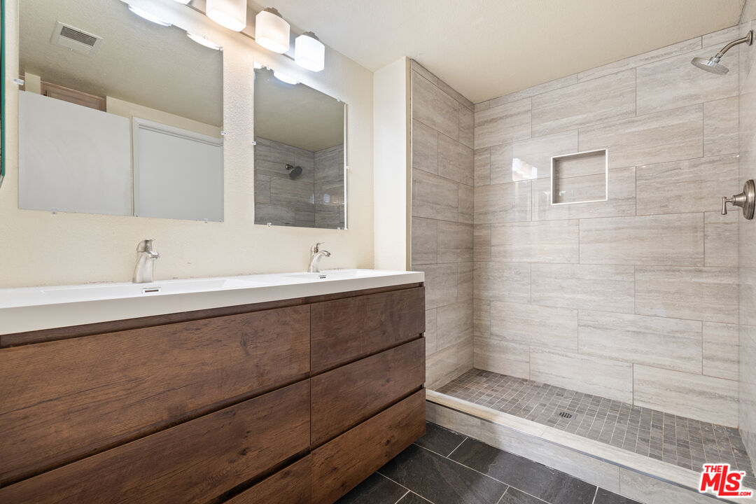 445 Ribbon Beach Way, Unit 277 Oceanside, CA 92058 - Photo 17 of 28 a bathroom with a sink and a mirror