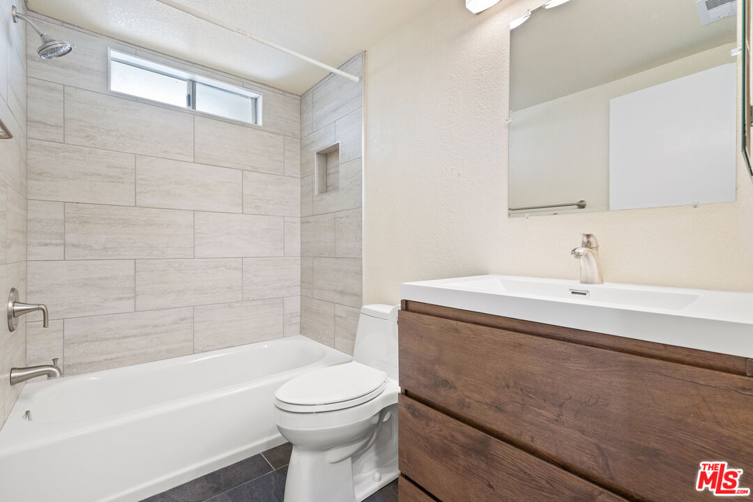 445 Ribbon Beach Way, Unit 277 Oceanside, CA 92058 - Photo 20 of 28 a bathroom with a sink a toilet and bathtub