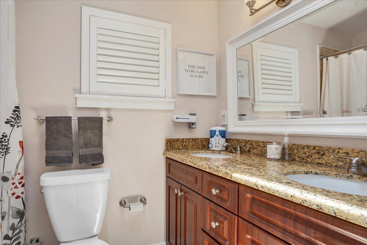 1110 Southwest 15th Street Boca Raton, FL 33486 - Photo 15 of 41 a bathroom with a granite countertop sink toilet and mirror