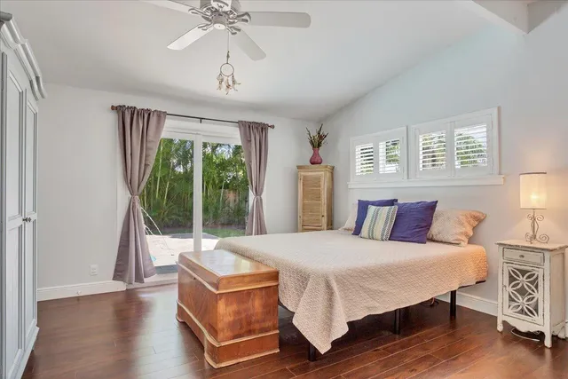 a living room with a bed furniture and a large window