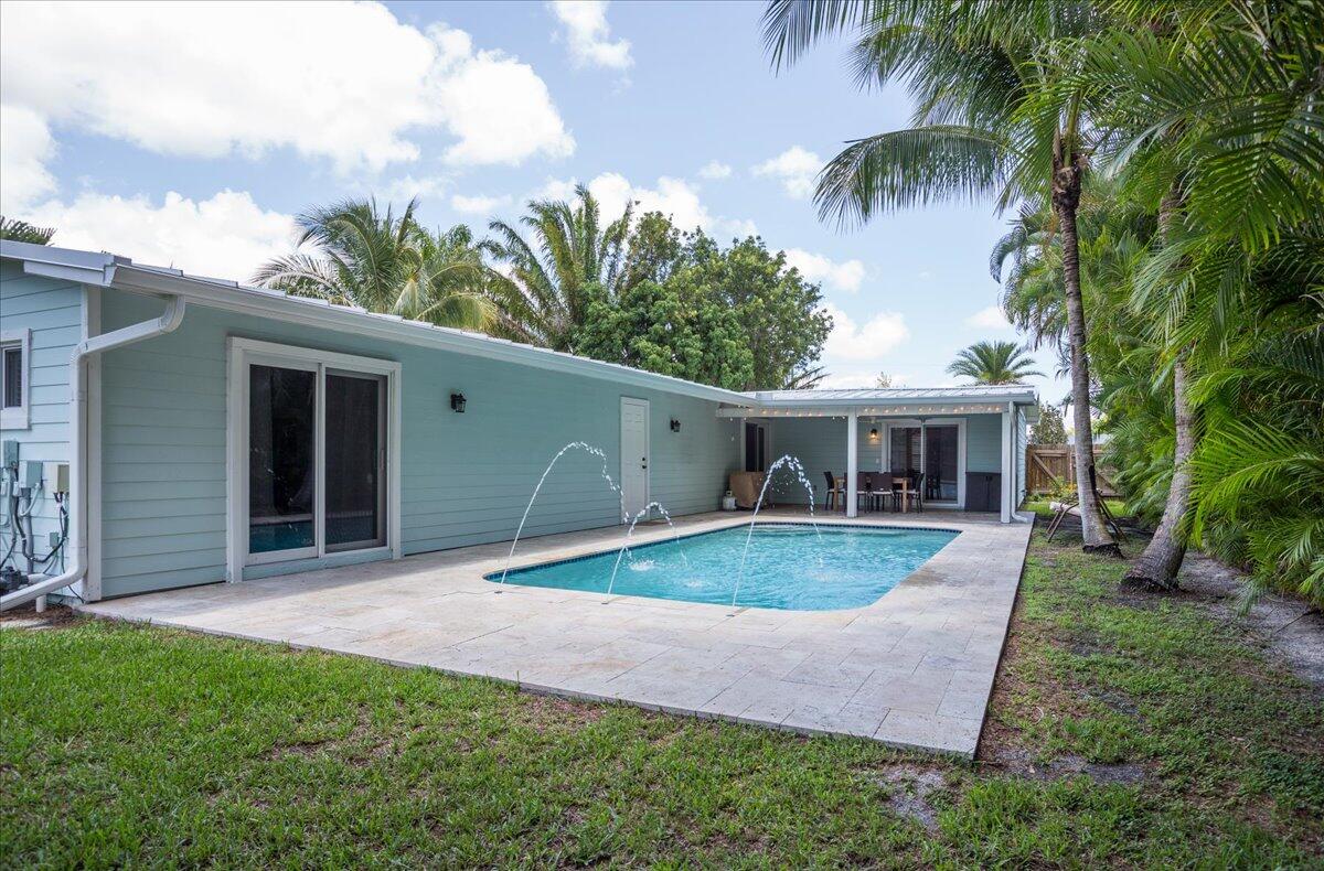 1110 Southwest 15th Street Boca Raton, FL 33486 - Photo 31 of 41 a front view of house with yard and outdoor seating