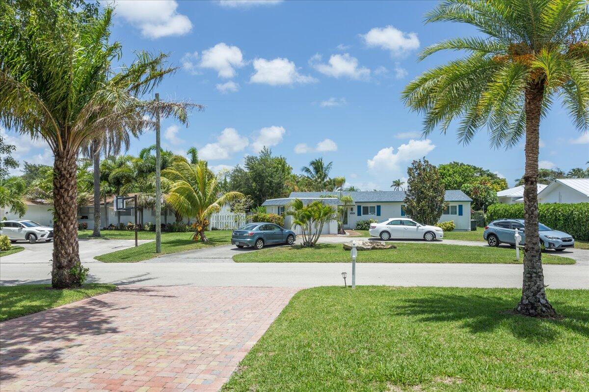 1110 Southwest 15th Street Boca Raton, FL 33486 - Photo 32 of 41 a view of a house with a big yard and palm trees