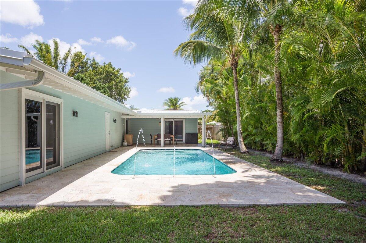 1110 Southwest 15th Street Boca Raton, FL 33486 - Photo 33 of 41 a view of a house with a yard and potted plants