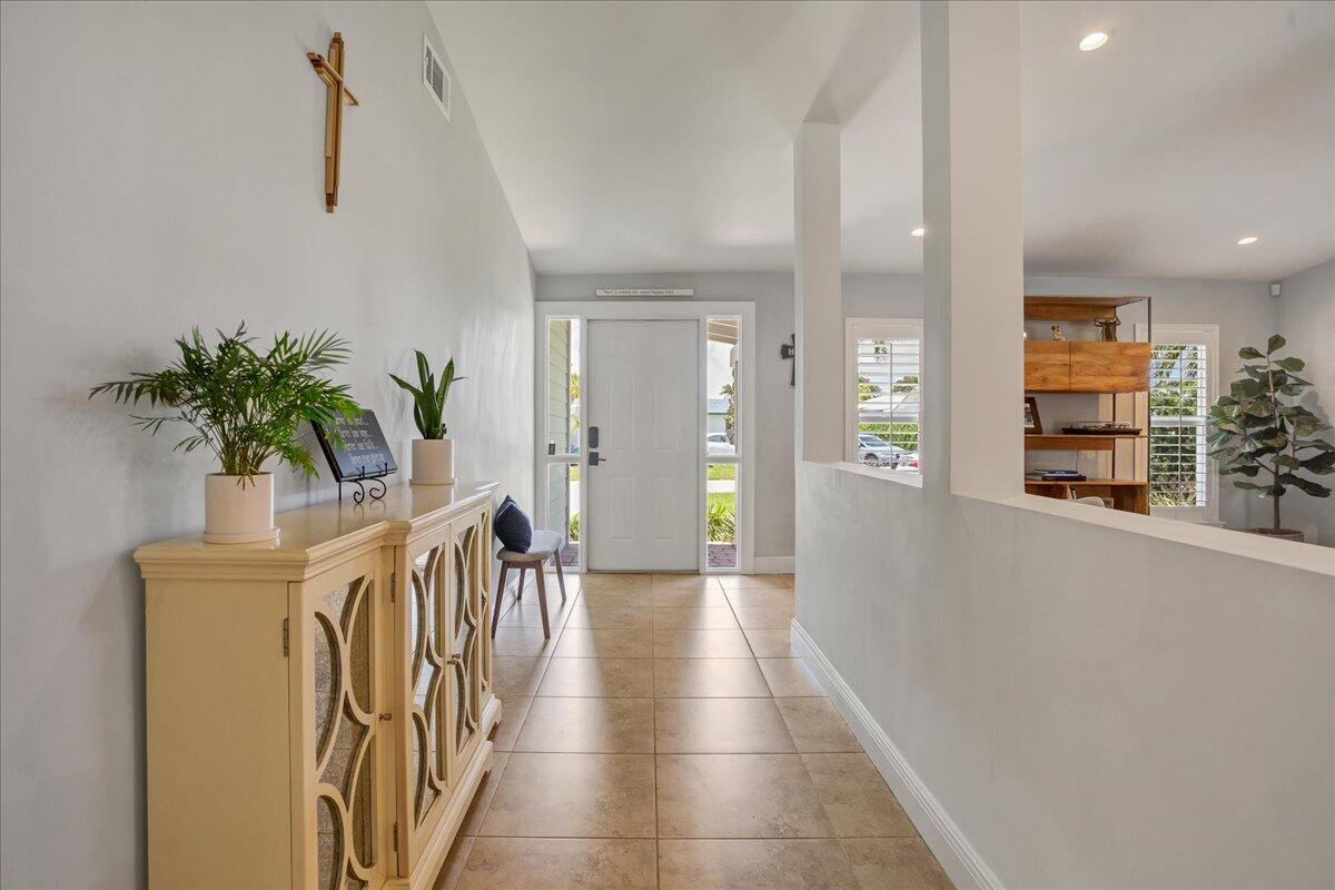 1110 Southwest 15th Street Boca Raton, FL 33486 - Photo 7 of 41 a hallway with wooden floor and a potted plant