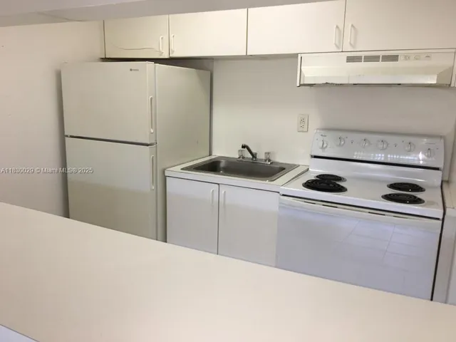 a kitchen with stainless steel appliances a refrigerator and a sink