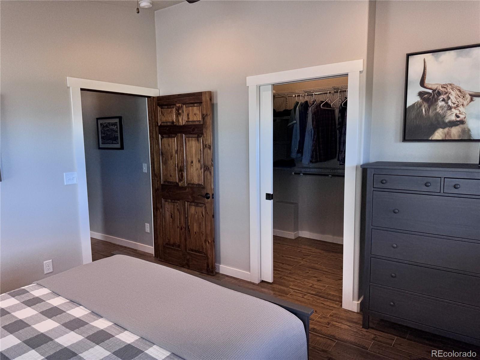 563 Kankakee Road Westcliffe, CO 81252 - Photo 15 of 46 a bedroom with a bed and a mirror on the dresser