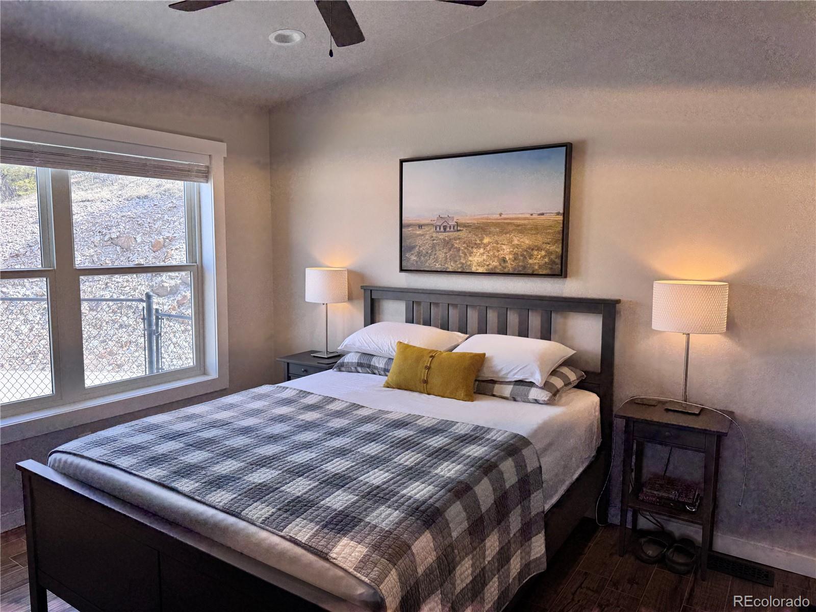 563 Kankakee Road Westcliffe, CO 81252 - Photo 16 of 46 a bedroom with a bed and a window