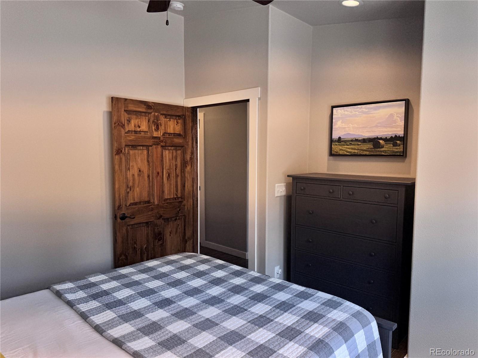 563 Kankakee Road Westcliffe, CO 81252 - Photo 17 of 46 a bedroom with a bed and a painting on the wall