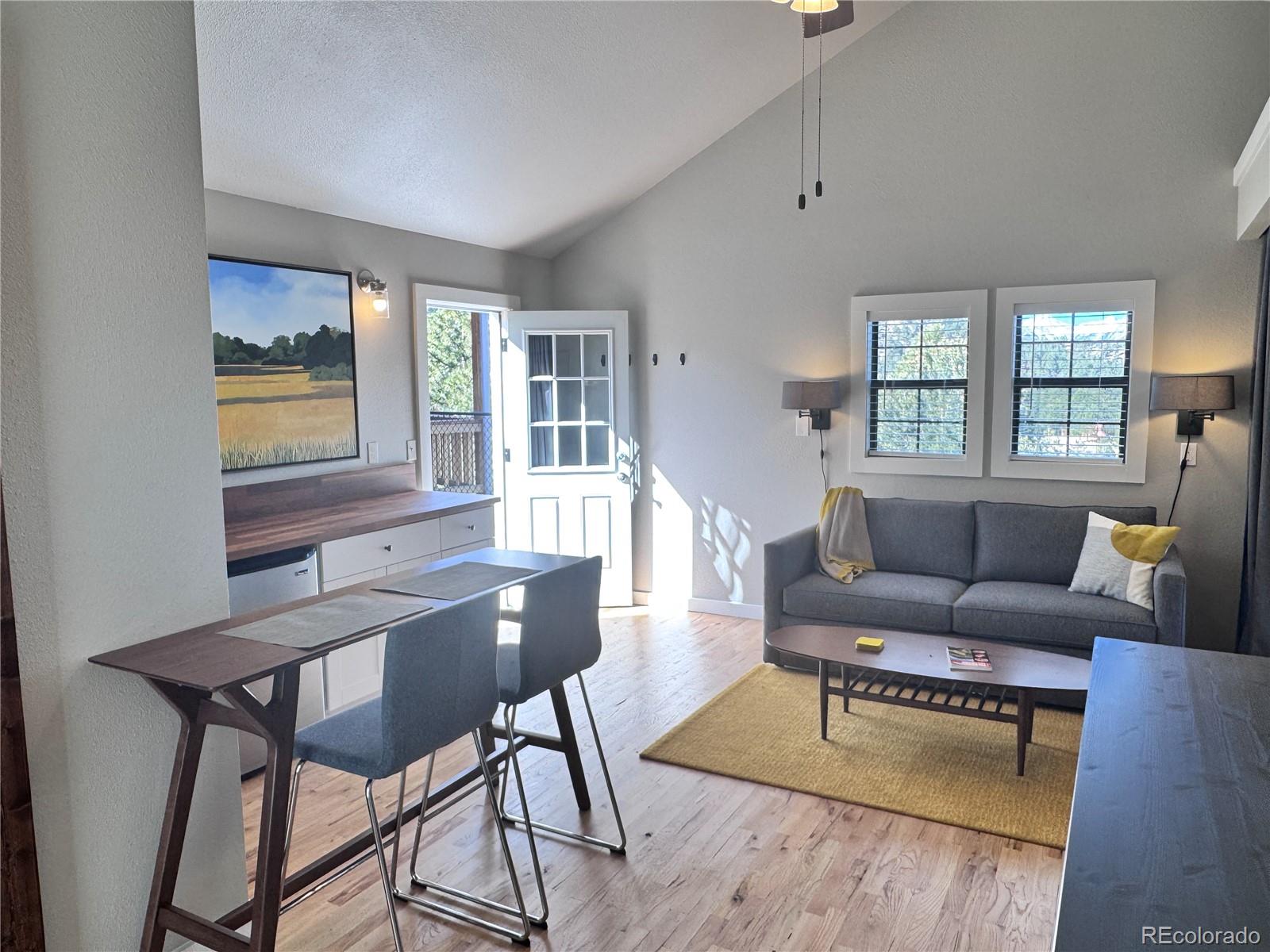 563 Kankakee Road Westcliffe, CO 81252 - Photo 32 of 46 a living room with furniture and a table with wooden floor