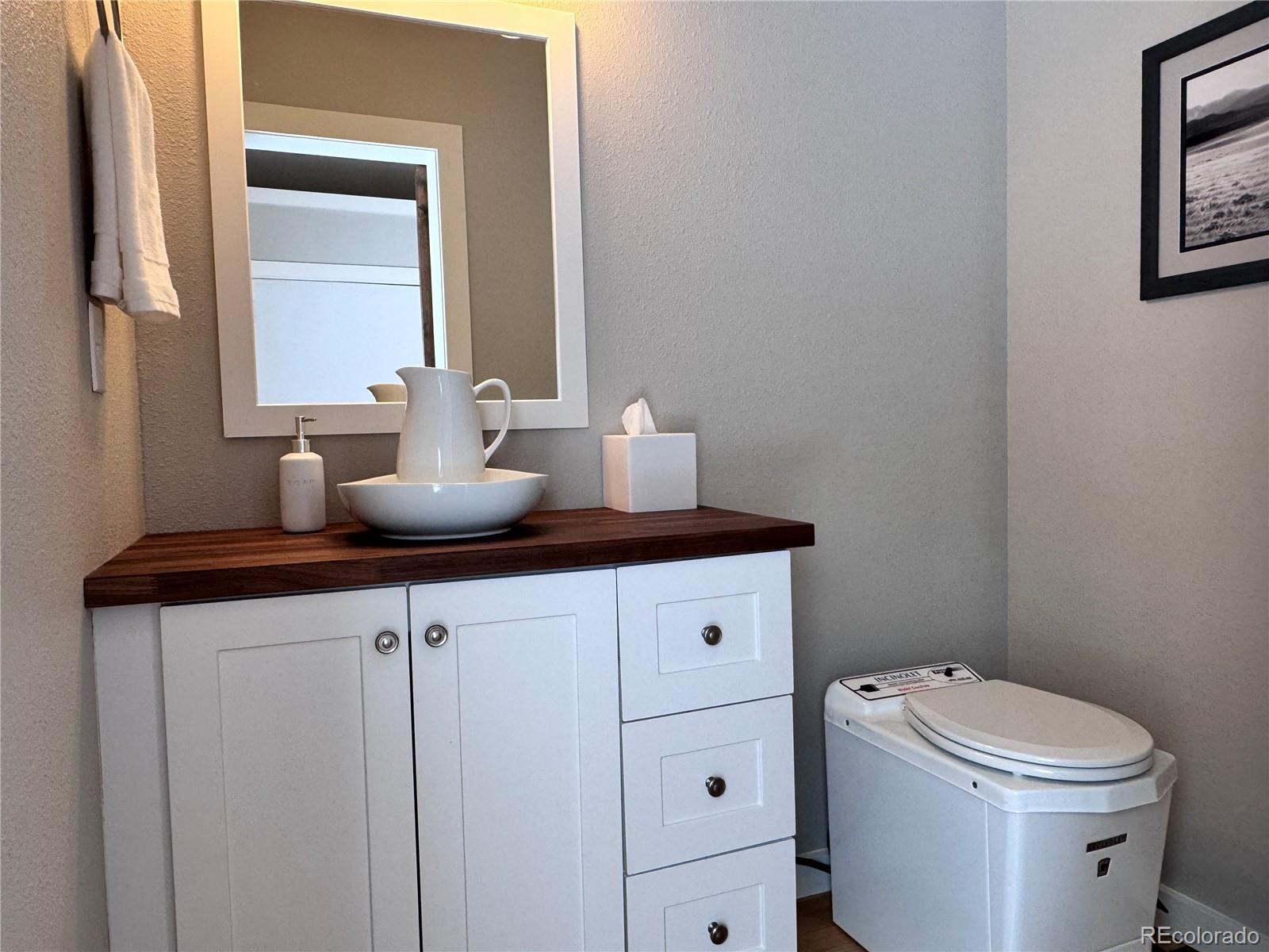 563 Kankakee Road Westcliffe, CO 81252 - Photo 36 of 46 a bathroom with a toilet sink and mirror