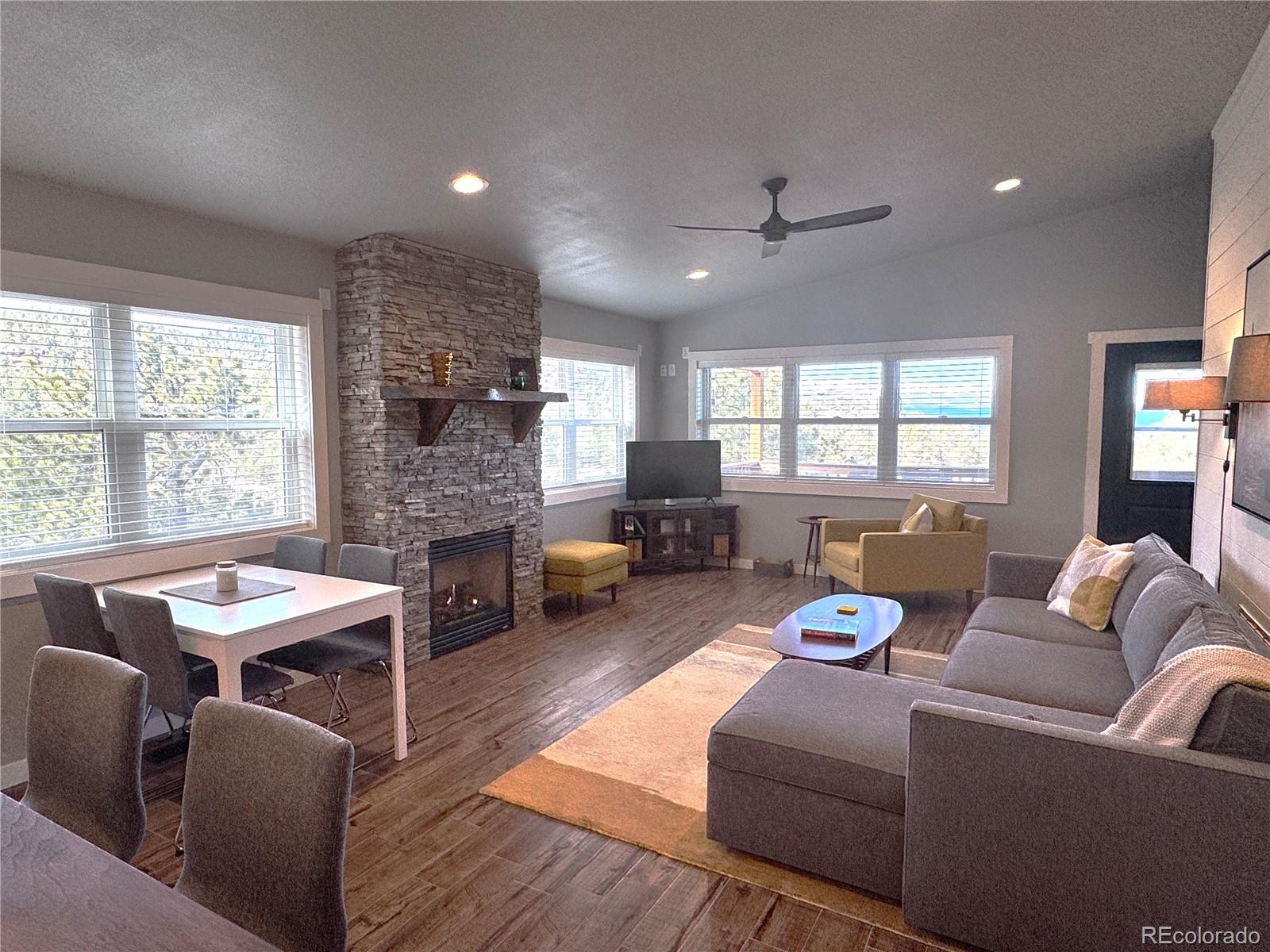 563 Kankakee Road Westcliffe, CO 81252 - Photo 5 of 46 a living room with furniture fireplace and a large window