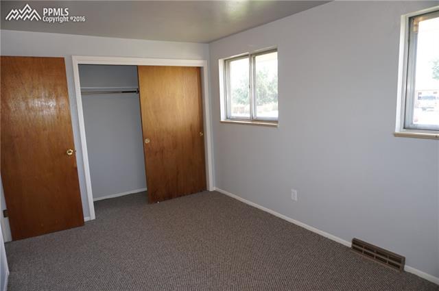 6 North Chelton Road Colorado Springs, CO 80909 - Photo 11 of 30 Bedroom #2 with hardwood floor under carpet