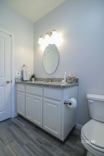 428 Scott Street Ridgecrest, CA 93555 - Photo 24 of 35 a bathroom with a granite countertop toilet sink and mirror