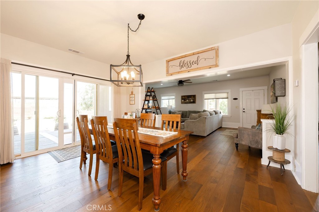 6488 County Road 20 Orland, CA 95963 - Photo 13 of 73 a dining room with furniture a chandelier and wooden floor
