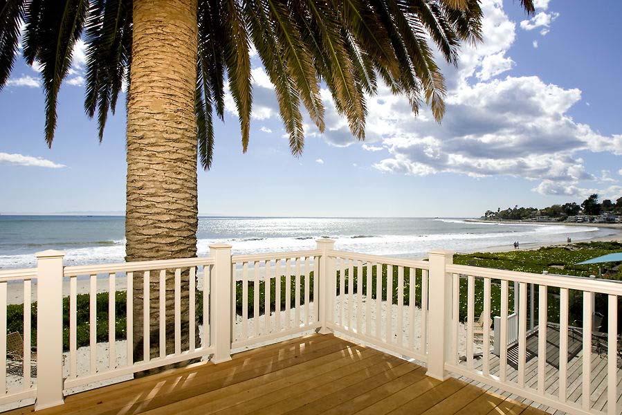 a view of a balcony with wooden floor and fence