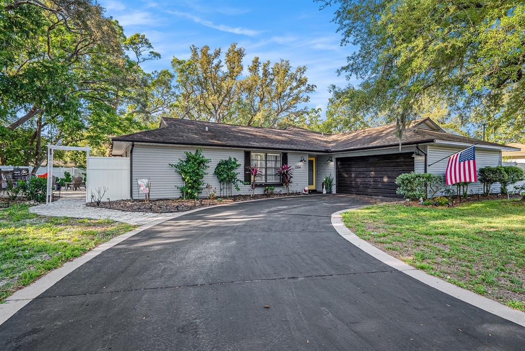 2254 Coachman Road Spring Hill, FL 34608 - Photo 1 of 1 a front view of a house with garden