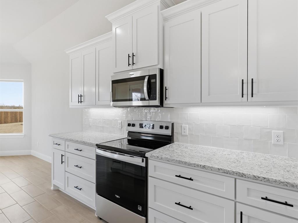 829 Haley Springtown, TX 76082 - Photo 15 of 37 a kitchen with white cabinets and appliances