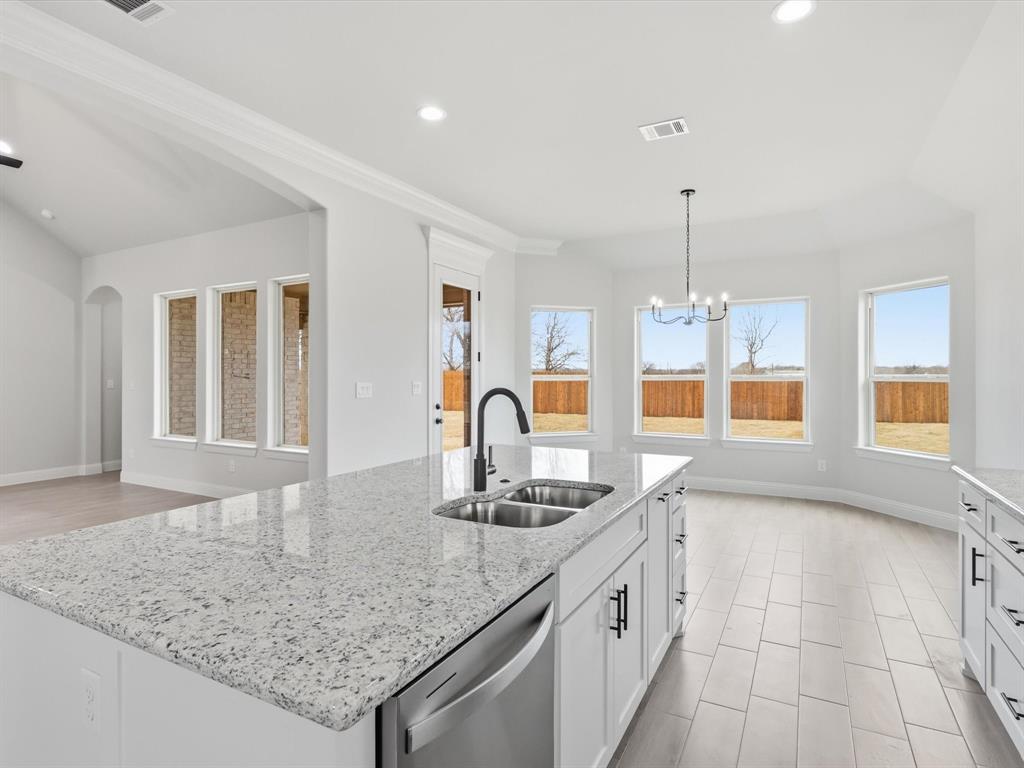 829 Haley Springtown, TX 76082 - Photo 16 of 37 a large kitchen with granite countertop a sink and white cabinets