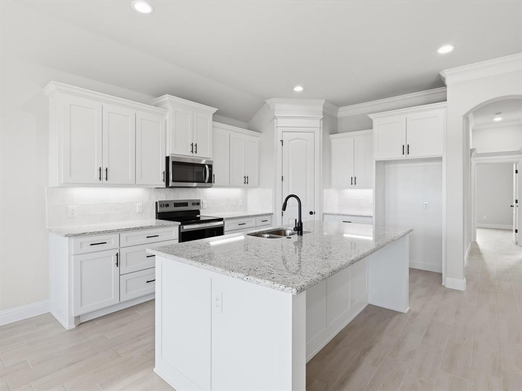 829 Haley Springtown, TX 76082 - Photo 18 of 37 a kitchen with white cabinets and stainless steel appliances