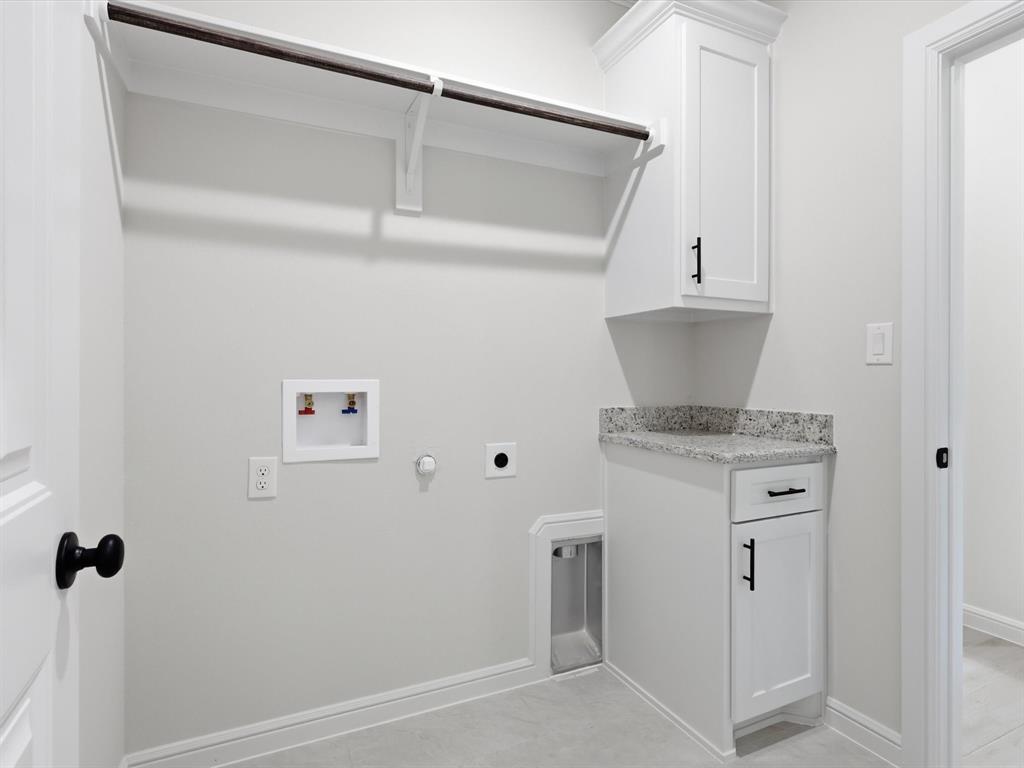 829 Haley Springtown, TX 76082 - Photo 29 of 37 a kitchen with a refrigerator and white cabinets