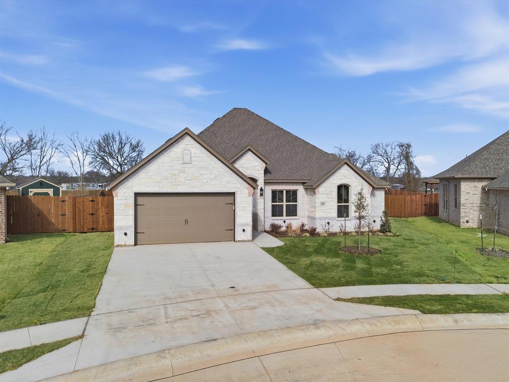 829 Haley Springtown, TX 76082 - Photo 34 of 37 a front view of a house with a yard and garage