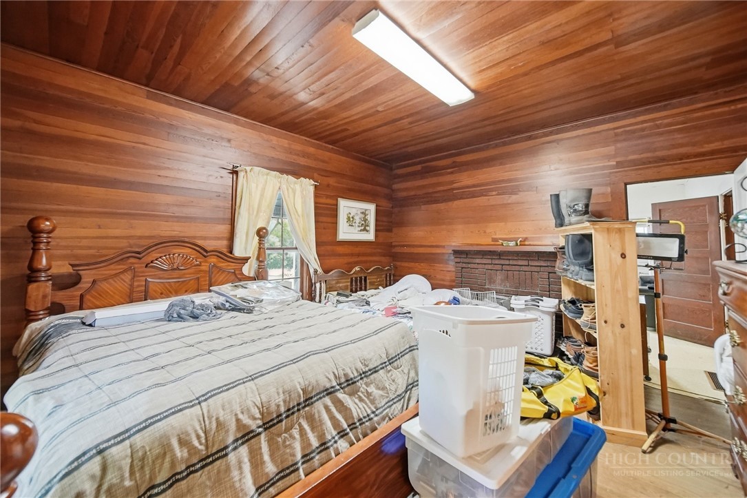 3450 Sparta Road North Wilkesboro, NC 28659 - Photo 12 of 34 a bed sitting in a bedroom next to a larger window