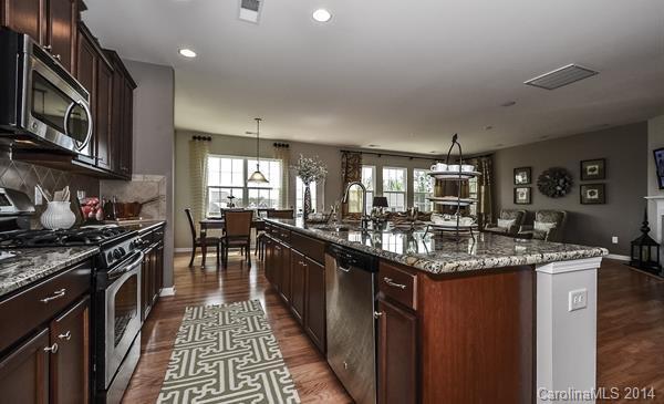 4308 Perth Road, Unit 320 Indian Land, SC 29707 - Photo 3 of 11 a kitchen with stainless steel appliances granite countertop a sink stove and cabinets