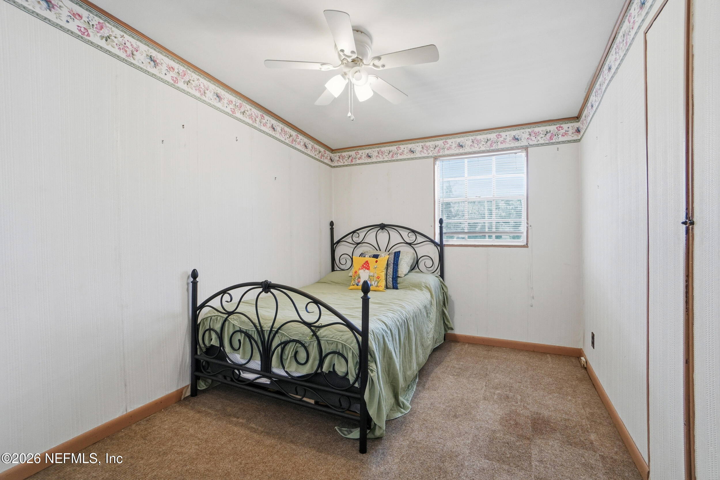 43 Forrestal Circle North Atlantic Beach, FL 32233 - Photo 19 of 39 a bedroom with a bed and a ceiling fan