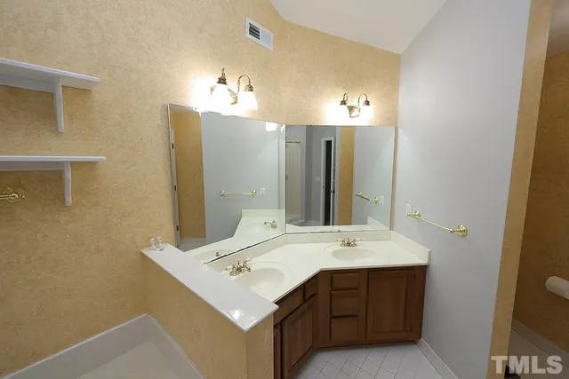a bathroom with a sink mirror and vanity