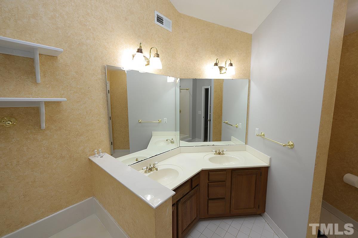 405 Lippershey Court Cary, NC 27513 - Photo 12 of 17 a bathroom with a sink mirror and vanity