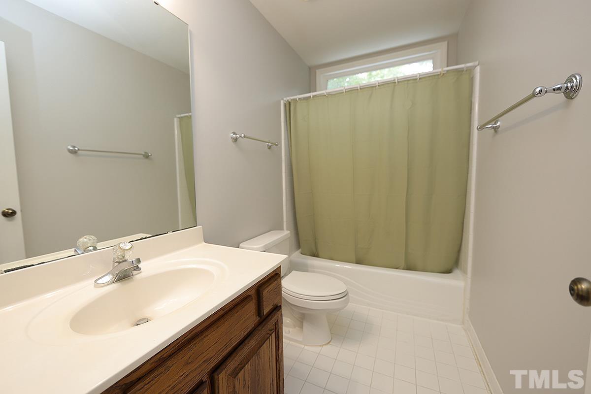 405 Lippershey Court Cary, NC 27513 - Photo 15 of 17 a bathroom with a sink a toilet and shower