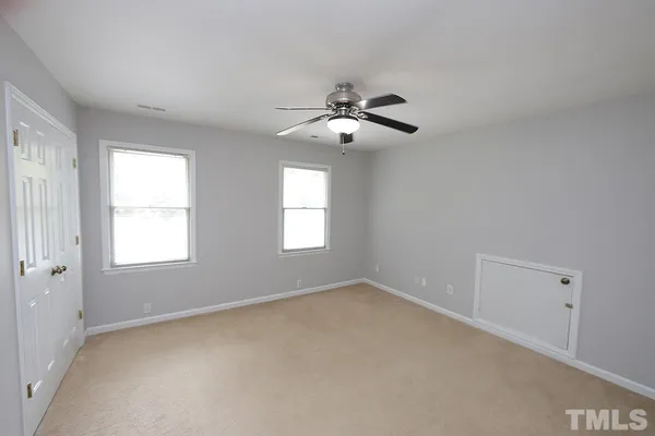 a view of room with a ceiling fan and window