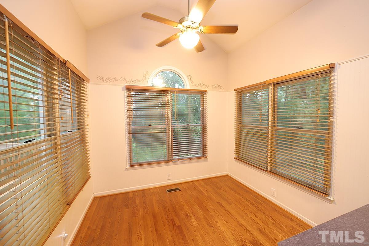 405 Lippershey Court Cary, NC 27513 - Photo 2 of 17 a view of an empty room with a window and wooden floor