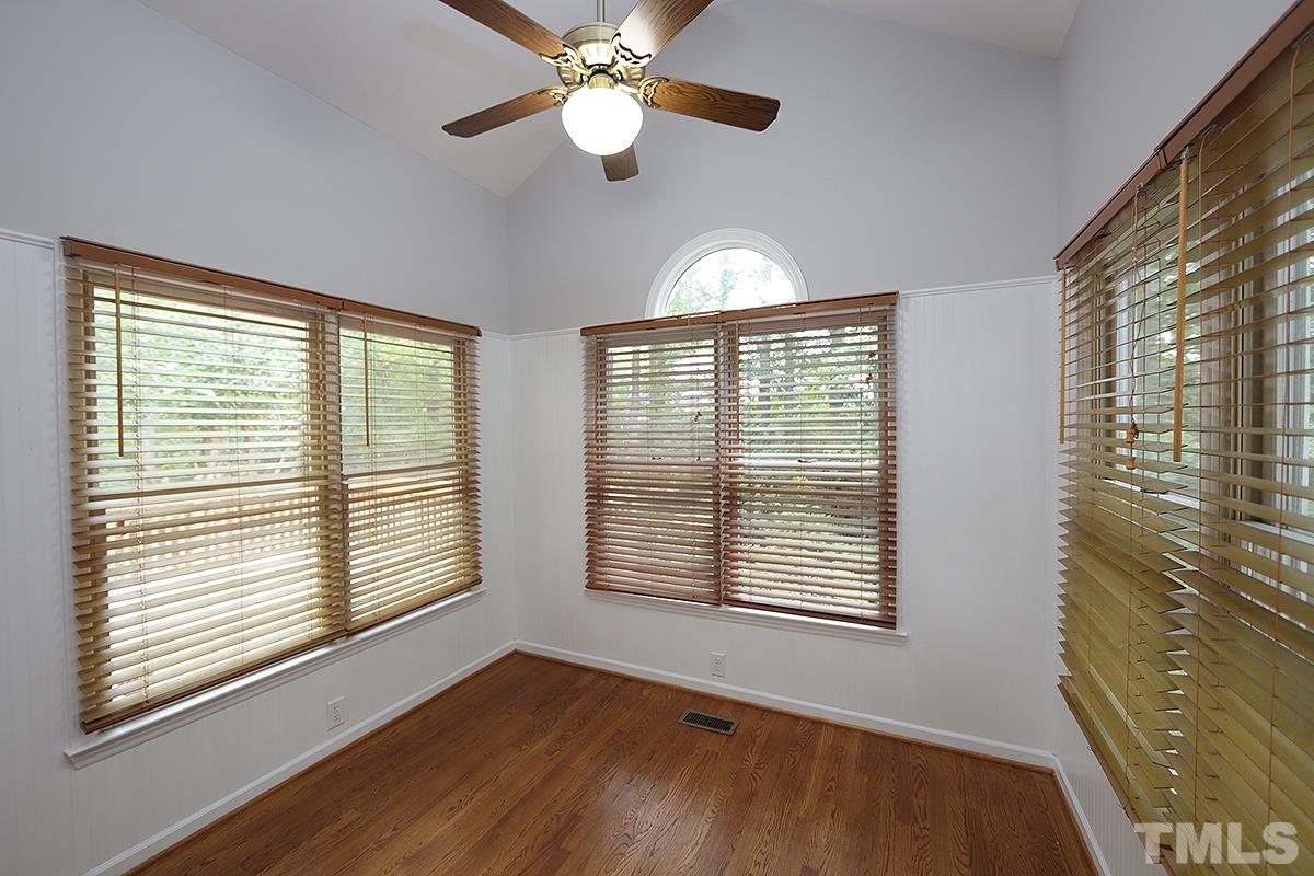 405 Lippershey Court Cary, NC 27513 - Photo 9 of 17 a view of an empty room with a window and wooden floor