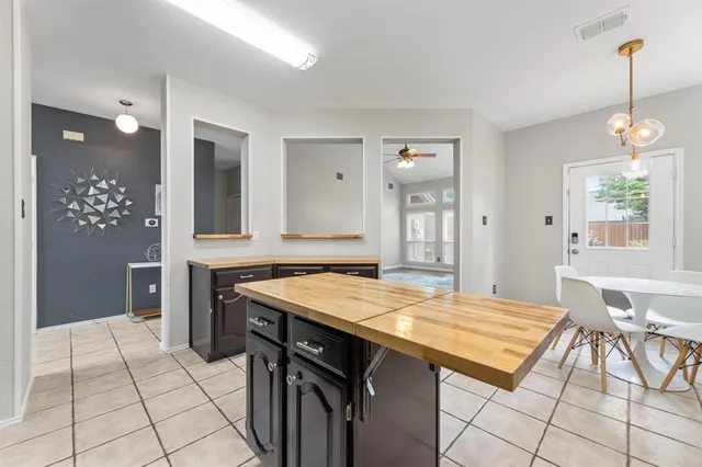 a kitchen that has a table and chairs in it