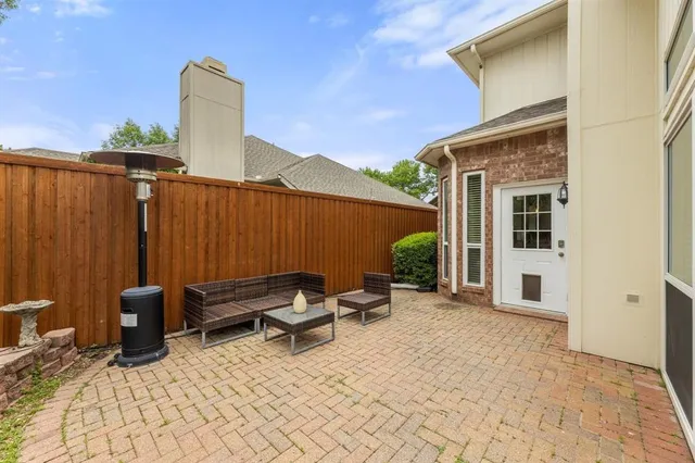a backyard of a house with outdoor seating
