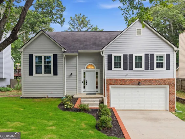 a front view of a house with a yard and garage