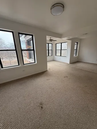 an empty room with windows and closet
