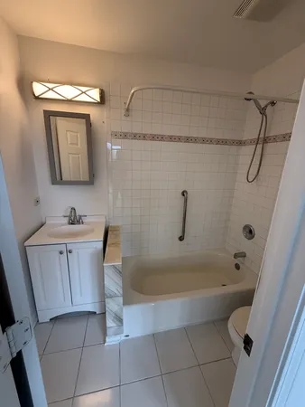 a bathroom with a tub a sink and a shower