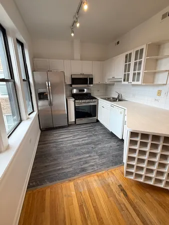 a kitchen with granite countertop a stove and cabinets