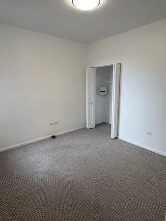 a view of an empty room and a window