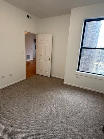 a view of an empty room with a window