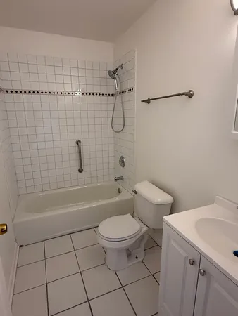 a bathroom with a toilet a sink and bathtub
