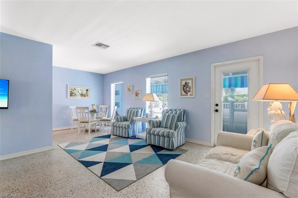 409 3rd Avenue North Naples, FL 34102 - Photo 14 of 41 a living room with furniture and a lamp