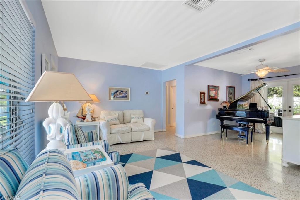 409 3rd Avenue North Naples, FL 34102 - Photo 15 of 41 a living room with furniture and a lamp