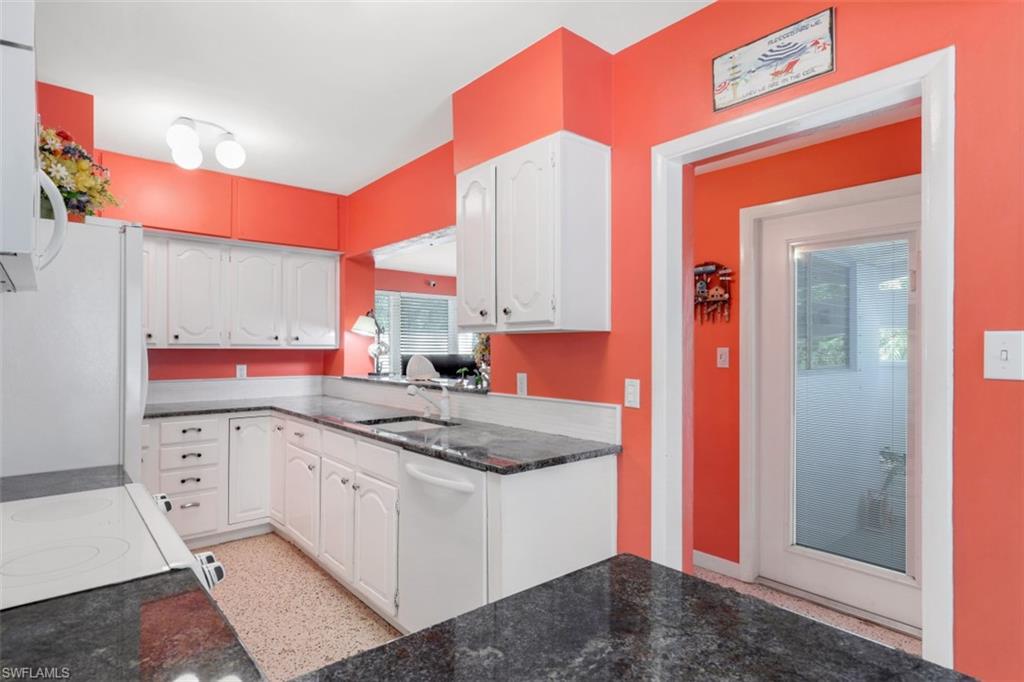 409 3rd Avenue North Naples, FL 34102 - Photo 17 of 41 a kitchen that has a sink and a stove