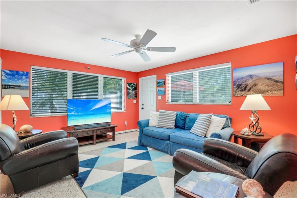 409 3rd Avenue North Naples, FL 34102 - Photo 19 of 41 a living room with furniture a rug and a large window